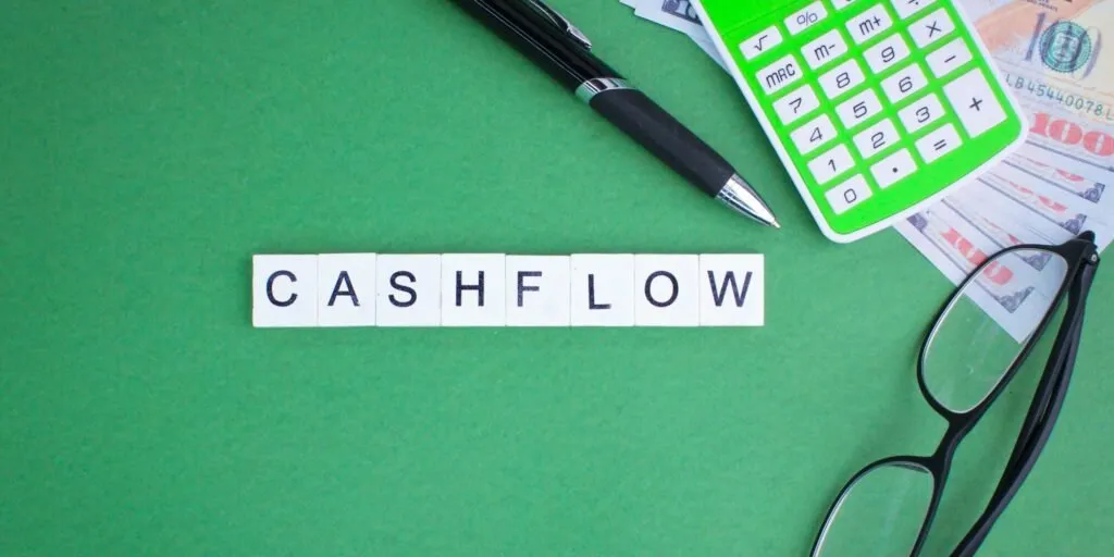 CASHFLOW text with office items and currency notes – Zidika Consulting, Kenya