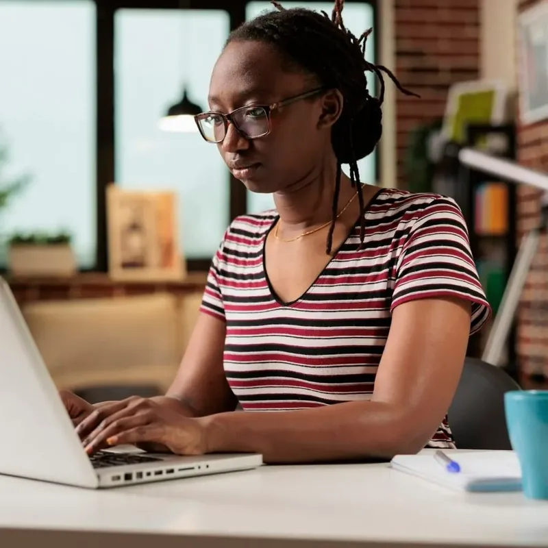 Woman in Nairobi filing tax returns on her laptop – Zidika Consulting, Kenya