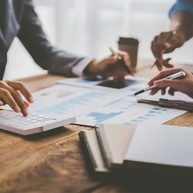 Three professionals reviewing accounting reports in a Kenyan office – Zidika Consulting