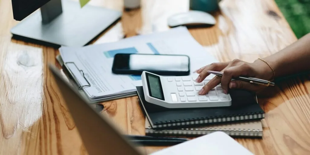 Bookkeeper recording transactions in a Nairobi office for a Kenyan business